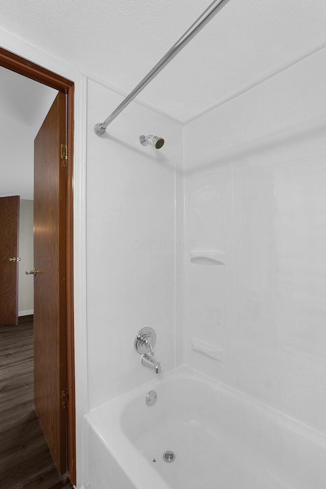 bathroom featuring hardwood / wood-style floors and shower / bath combination