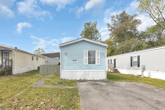 exterior space featuring a lawn and a carport