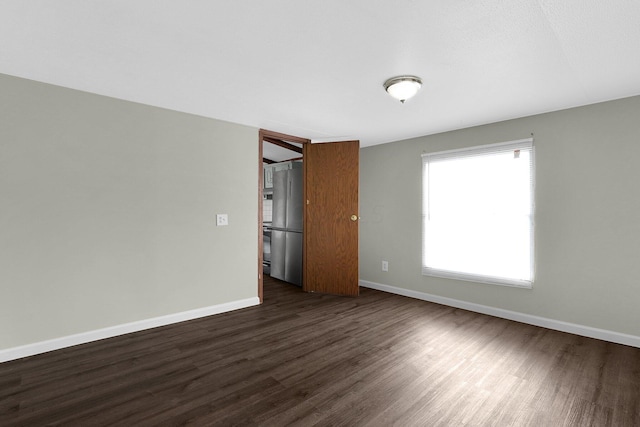 empty room featuring dark wood-type flooring