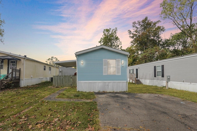 exterior space featuring a yard and a carport