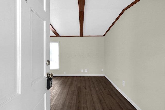 interior space featuring ornamental molding, vaulted ceiling with beams, and dark wood-type flooring