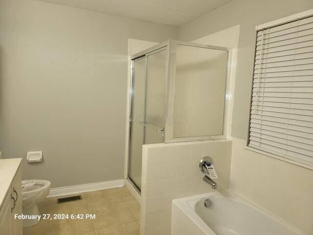 full bathroom featuring tile patterned floors, plus walk in shower, vanity, and toilet