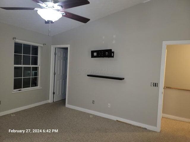 spare room with ceiling fan and carpet floors