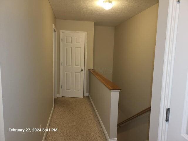 corridor with a textured ceiling