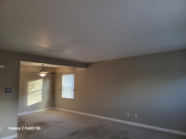 carpeted spare room with a textured ceiling