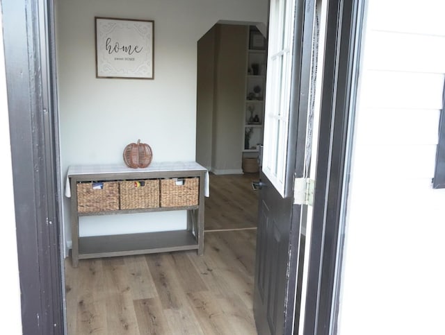 corridor with light hardwood / wood-style flooring