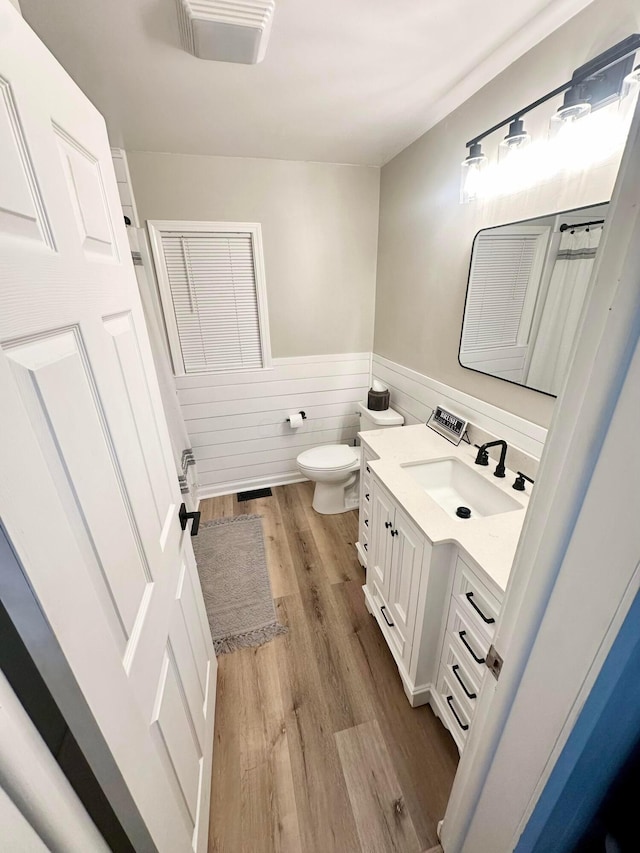 bathroom featuring hardwood / wood-style flooring, vanity, and toilet