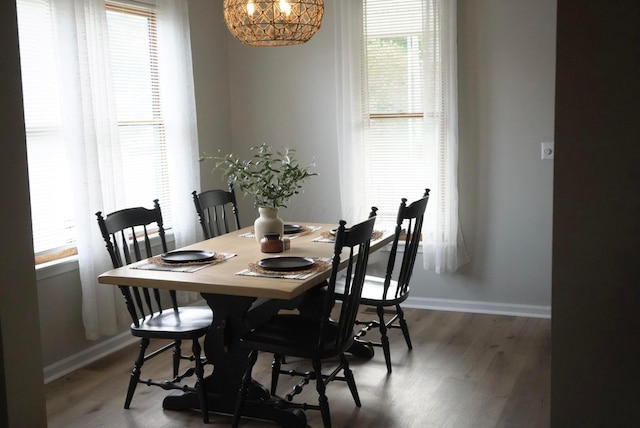 dining area with a wealth of natural light and dark wood-type flooring