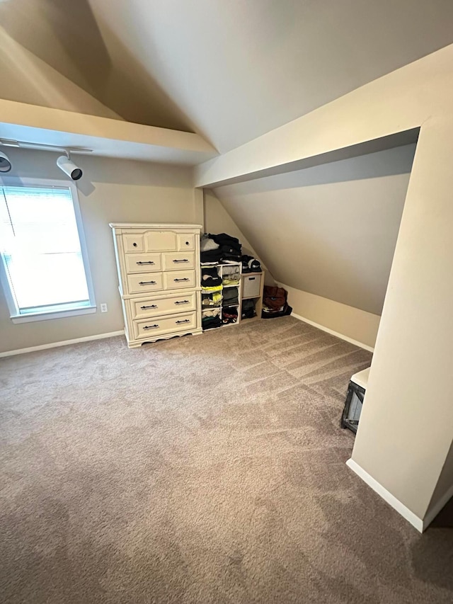 bonus room with carpet floors and vaulted ceiling