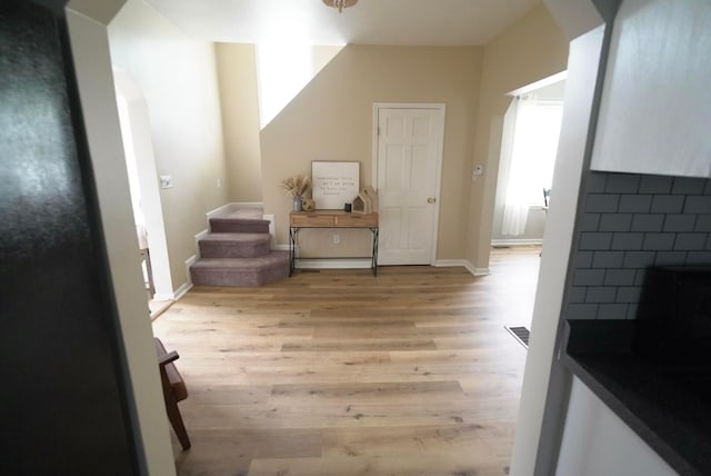 additional living space with a fireplace and light hardwood / wood-style flooring