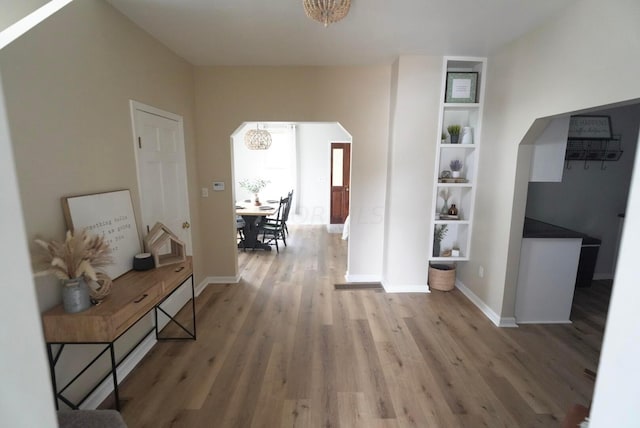 corridor with hardwood / wood-style floors