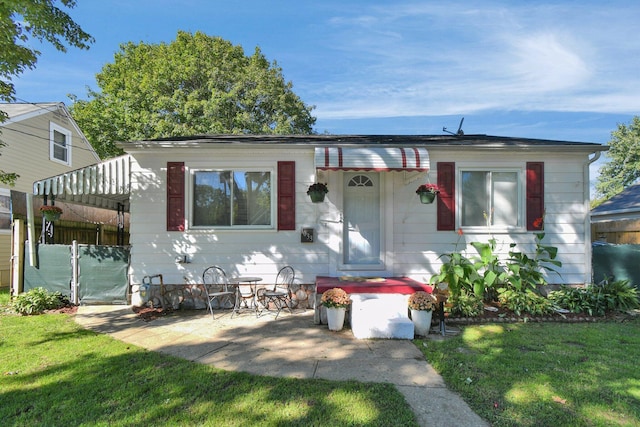 view of front facade with a patio area and a front yard