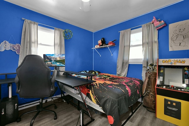 bedroom with dark hardwood / wood-style floors and ceiling fan