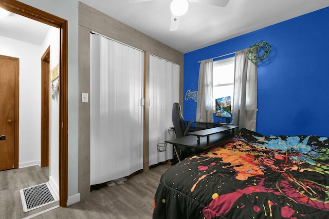 bedroom with ceiling fan and hardwood / wood-style floors