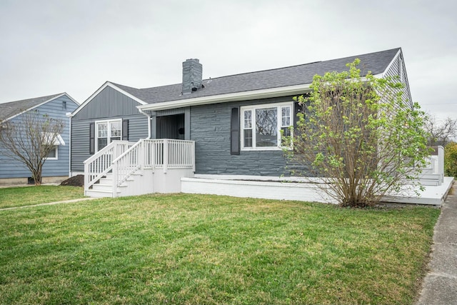 rear view of house featuring a yard