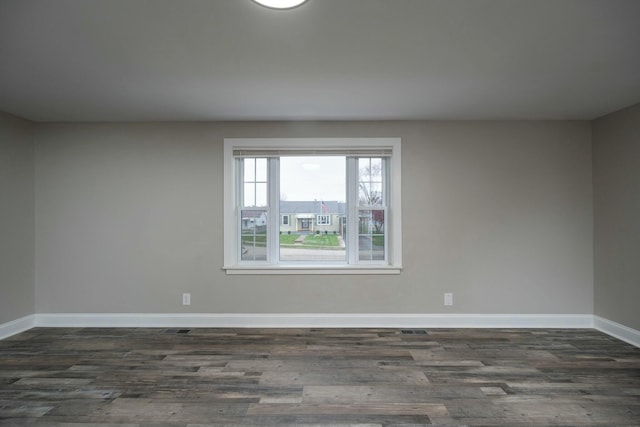 spare room featuring dark wood-type flooring