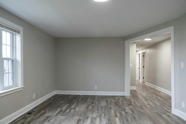 spare room featuring dark hardwood / wood-style flooring