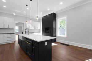 1571 Dyer Rd, Grove City, OH 43123 - kitchen featuring dark cabinets, dark wood-style flooring, light countertops, ornamental molding, and pendant lighting