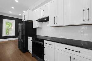 1571 Dyer Rd, Grove City, OH 43123 - kitchen featuring under cabinet range hood, dark wood-style flooring, recessed lighting, backsplash, and white cabinets