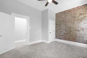 1571 Dyer Rd, Grove City, OH 43123 - spare room featuring brick wall and ceiling fan