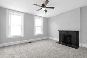 1571 Dyer Rd, Grove City, OH 43123 - unfurnished living room featuring plenty of natural light, carpet floors, and a ceiling fan
