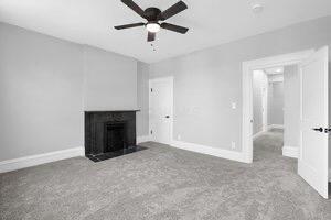 1571 Dyer Rd, Grove City, OH 43123 - unfurnished living room with a ceiling fan, a fireplace with flush hearth, and carpet floors