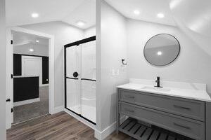 1571 Dyer Rd, Grove City, OH 43123 - bathroom with vanity, wood finished floors, a shower stall, vaulted ceiling, and recessed lighting