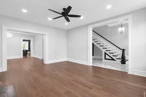 1571 Dyer Rd, Grove City, OH 43123 - unfurnished living room featuring stairway, wood finished floors, recessed lighting, a chandelier, and ceiling fan
