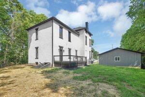 1571 Dyer Rd, Grove City, OH 43123 - back of property featuring a chimney, a yard, and stucco siding