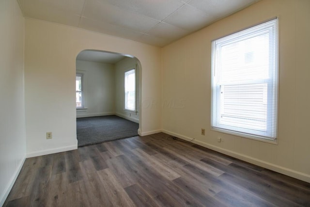 unfurnished room with dark hardwood / wood-style flooring