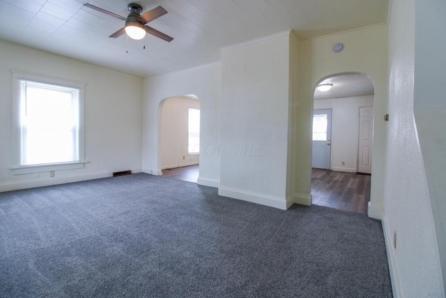 carpeted empty room with ceiling fan and ornamental molding