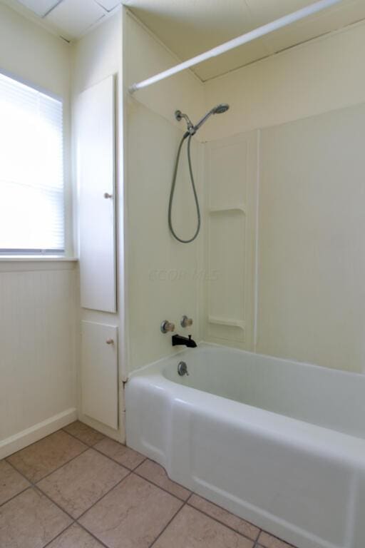 bathroom featuring tile patterned flooring and shower / tub combination