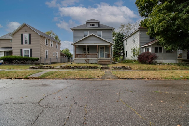 view of front of property featuring a front lawn and a porch