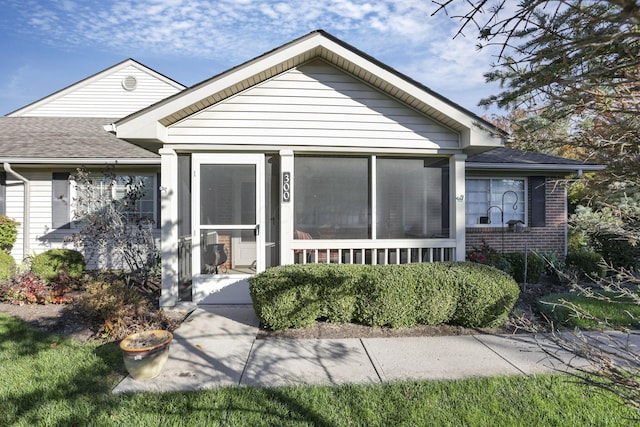 bungalow-style home featuring a sunroom