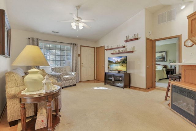 living room with ceiling fan, high vaulted ceiling, and light colored carpet