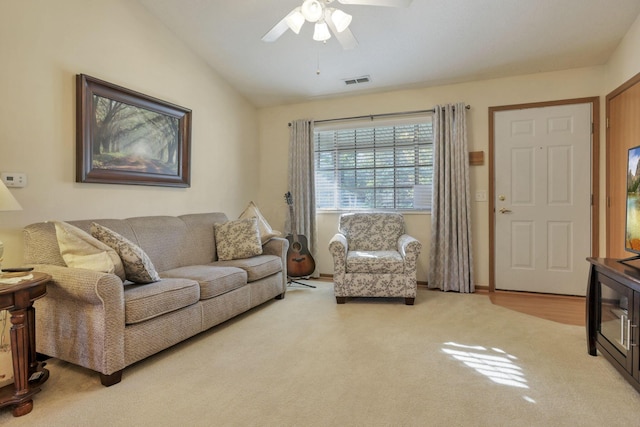 carpeted living room featuring ceiling fan and lofted ceiling