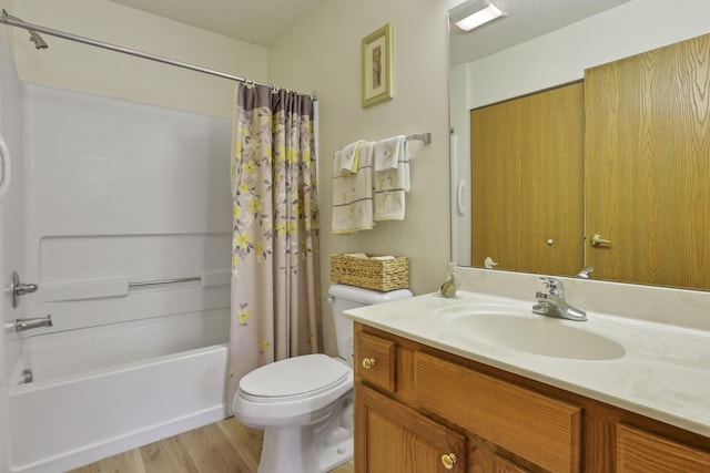 full bathroom with hardwood / wood-style floors, vanity, toilet, and shower / bath combo