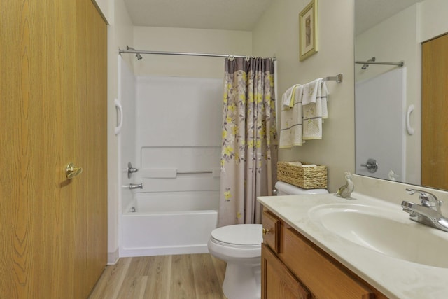 full bathroom with hardwood / wood-style floors, vanity, toilet, and shower / tub combo with curtain