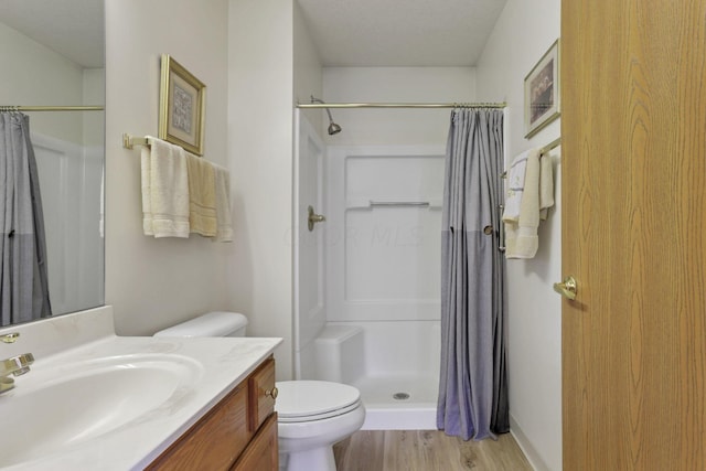 bathroom featuring hardwood / wood-style floors, vanity, toilet, and a shower with shower curtain