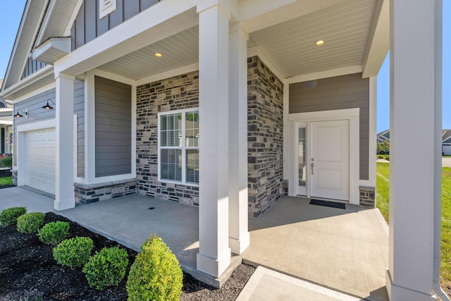 property entrance with covered porch and a garage