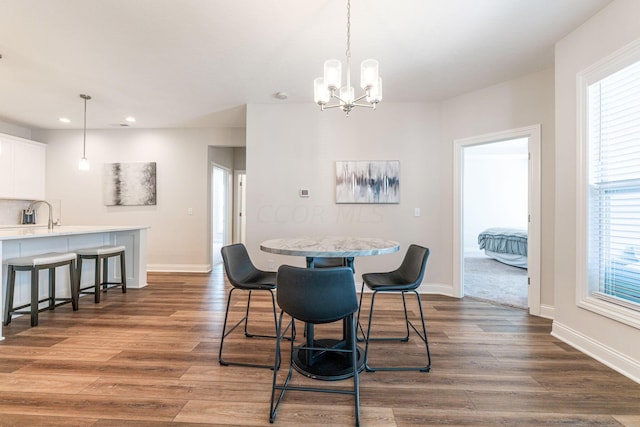 dining room featuring dark hardwood / wood-style flooring and an inviting chandelier