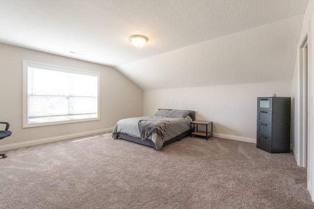 carpeted bedroom featuring lofted ceiling