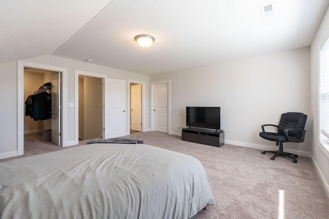 bedroom featuring light carpet and vaulted ceiling