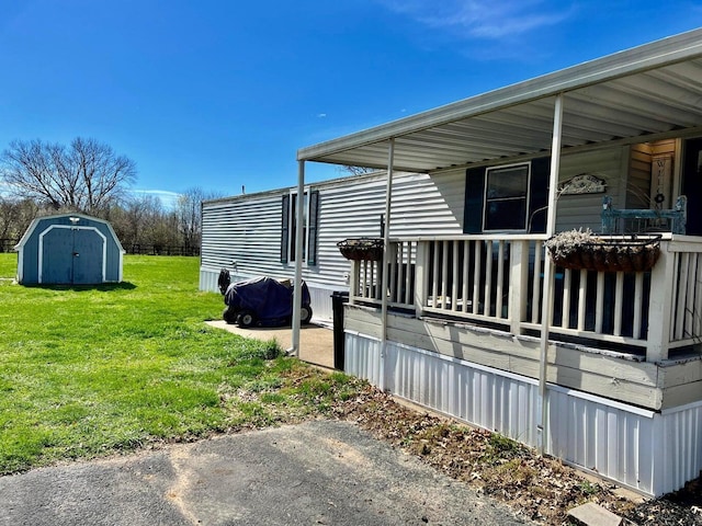 view of home's exterior with a yard and a storage shed