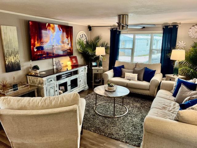 living room with ceiling fan, crown molding, and wood-type flooring