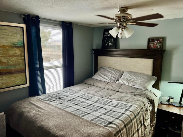 bedroom with a textured ceiling and ceiling fan