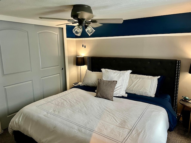 bedroom featuring ceiling fan and carpet