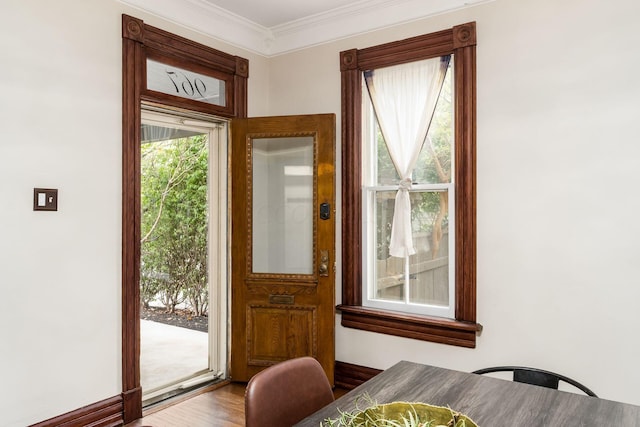 doorway featuring wood-type flooring and ornamental molding