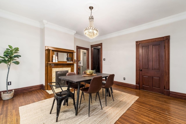 dining space featuring a notable chandelier, dark hardwood / wood-style floors, and ornamental molding