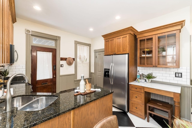 kitchen with decorative backsplash, dark stone countertops, sink, and appliances with stainless steel finishes